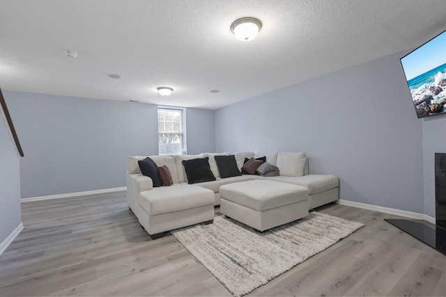 6310 Wagtail Rd Unit 6, Columbus, OH 43230 - living area with baseboards, light wood-type flooring, and a textured ceiling