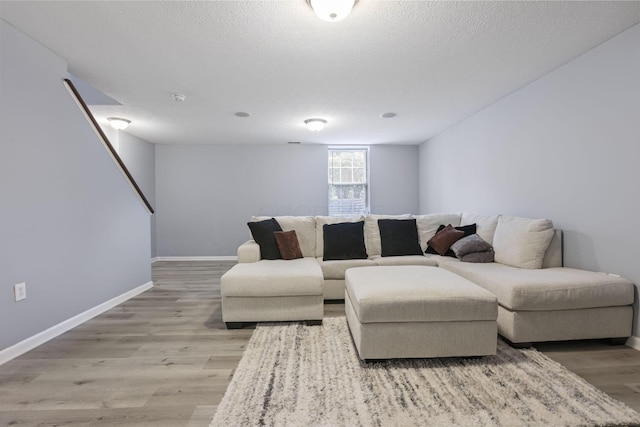 6310 Wagtail Rd Unit 6, Columbus, OH 43230 - living room with light wood finished floors, baseboards, and a textured ceiling