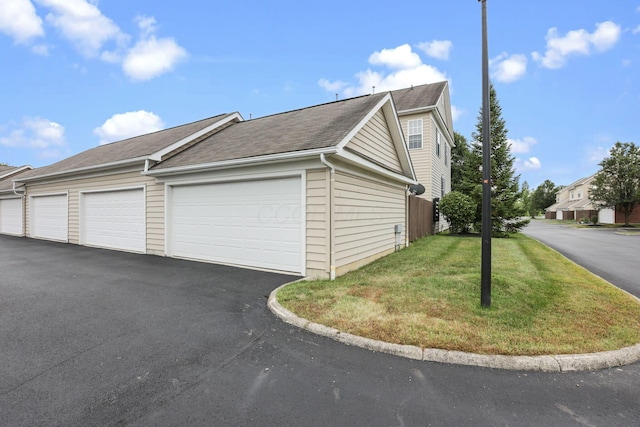 6310 Wagtail Rd Unit 6, Columbus, OH 43230 - view of side of home with a yard, roof with shingles, and community garages