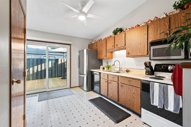 797 Timber Way Dr Unit 16C, Columbus, OH 43085 - kitchen with stainless steel appliances, light flooring, a sink, light countertops, and vaulted ceiling