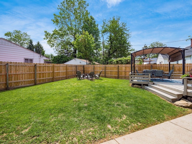 5298 Crawford Dr, Columbus, OH 43229 - view of yard with an outdoor living space with a fire pit and a wooden deck