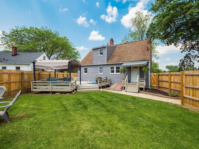 5298 Crawford Dr, Columbus, OH 43229 - rear view of house with a wooden deck, a chimney, entry steps, and a shingled roof