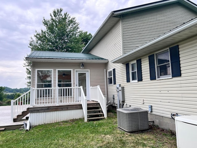 20600 Hellwig Rd, Utica, OH 43080 - rear view of property with central AC unit, a lawn, stairs, metal roof, and a wooden deck