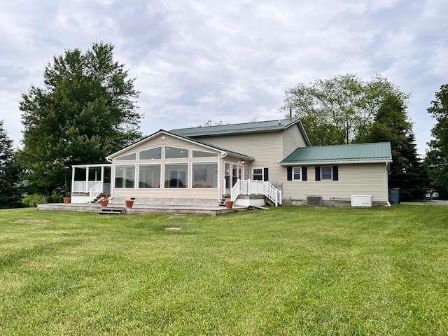20600 Hellwig Rd, Utica, OH 43080 - back of property with a sunroom, central AC, metal roof, and a yard