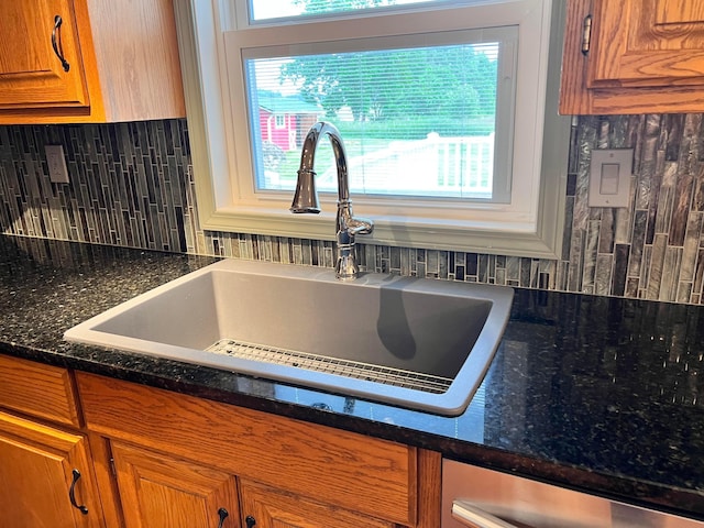 20600 Hellwig Rd, Utica, OH 43080 - kitchen with a sink, brown cabinets, backsplash, and dark stone countertops
