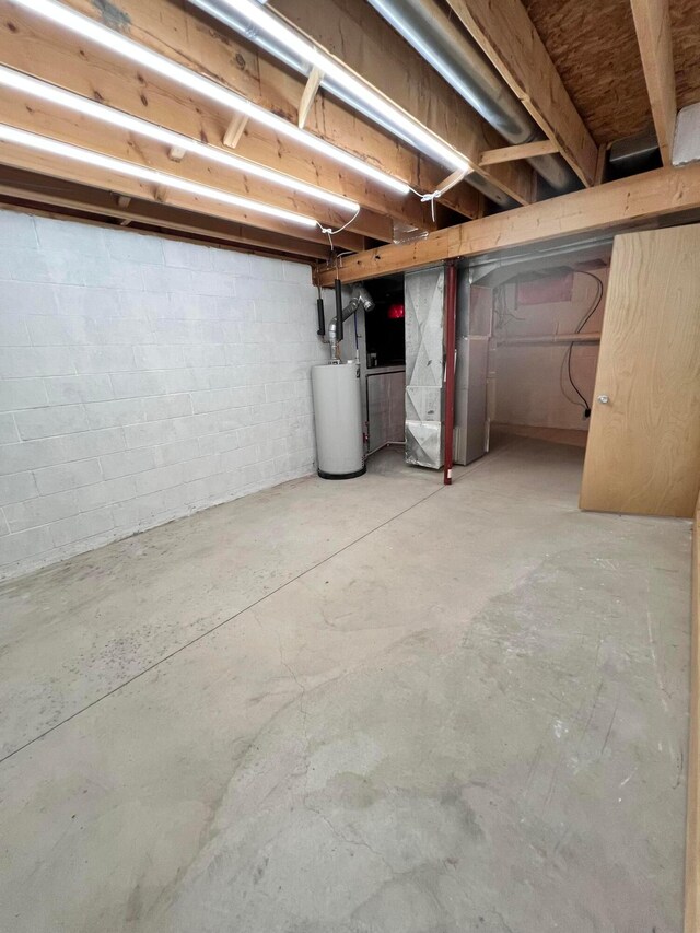 20600 Hellwig Rd, Utica, OH 43080 - unfinished basement with water heater, heating unit, and concrete block wall