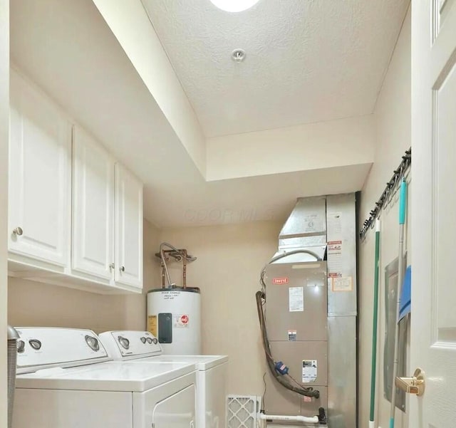 5935 N High St Unit 202, Worthington, OH 43085 - laundry room with cabinet space, water heater, washing machine and clothes dryer, heating unit, and a textured ceiling