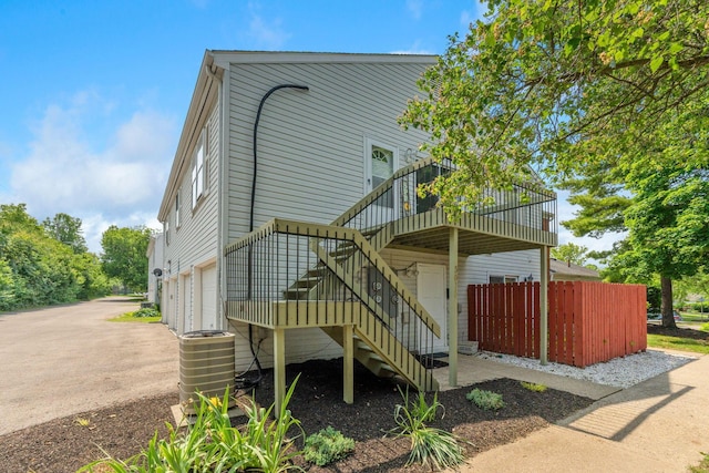 3013 La Vista Dr Unit 29, Columbus, OH 43204 - view of front of home featuring an attached garage, central air condition unit, stairs, and a wooden deck