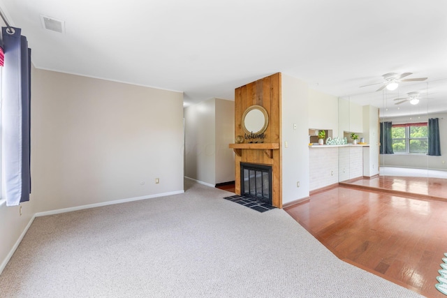 3013 La Vista Dr Unit 29, Columbus, OH 43204 - unfurnished living room featuring ceiling fan, baseboards, a large fireplace, and carpet