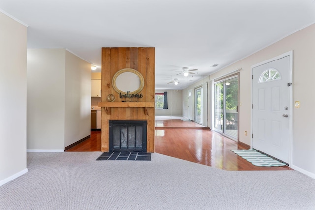 3013 La Vista Dr Unit 29, Columbus, OH 43204 - entryway featuring carpet, ceiling fan, baseboards, a tile fireplace, and ornamental molding