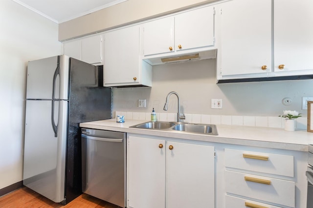 3013 La Vista Dr Unit 29, Columbus, OH 43204 - kitchen with a sink, stainless steel appliances, white cabinets, light countertops, and ornamental molding