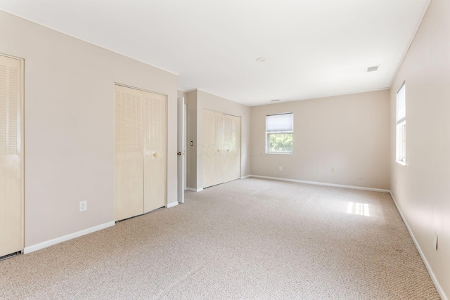 3013 La Vista Dr Unit 29, Columbus, OH 43204 - unfurnished bedroom with two closets, carpet flooring, and baseboards