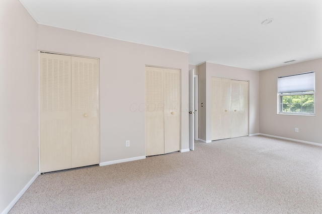3013 La Vista Dr Unit 29, Columbus, OH 43204 - unfurnished bedroom featuring carpet, multiple closets, and baseboards
