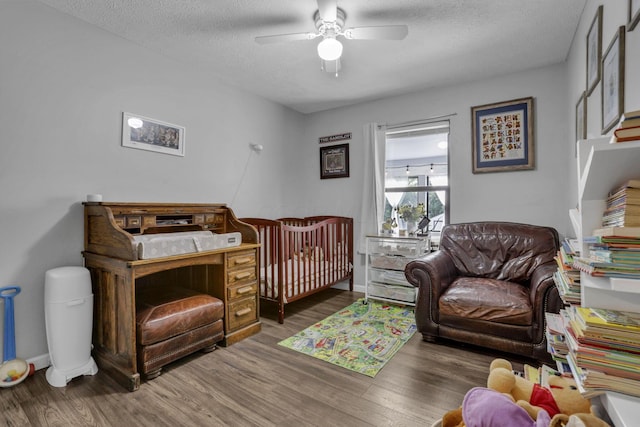 3149 Bowdoin Cir, Columbus, OH 43204 - bedroom featuring wood finished floors, a textured ceiling, baseboards, and a ceiling fan
