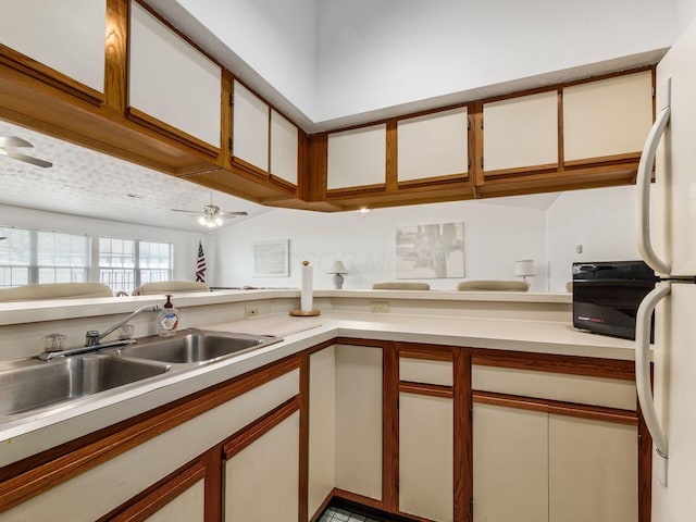 4393 Hammerton Dr Unit 14B, Columbus, OH 43228 - kitchen with light countertops, ceiling fan, freestanding refrigerator, and white cabinetry