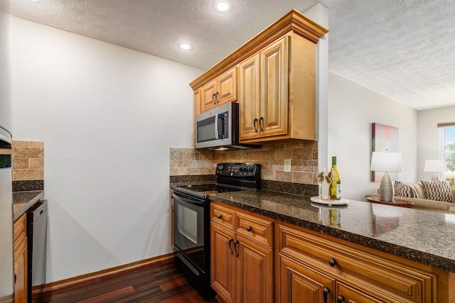 4393 Hammerton Dr Unit 14B, Columbus, OH 43228 - kitchen featuring stainless steel appliances, dark wood-style floors, a textured ceiling, decorative backsplash, and open floor plan