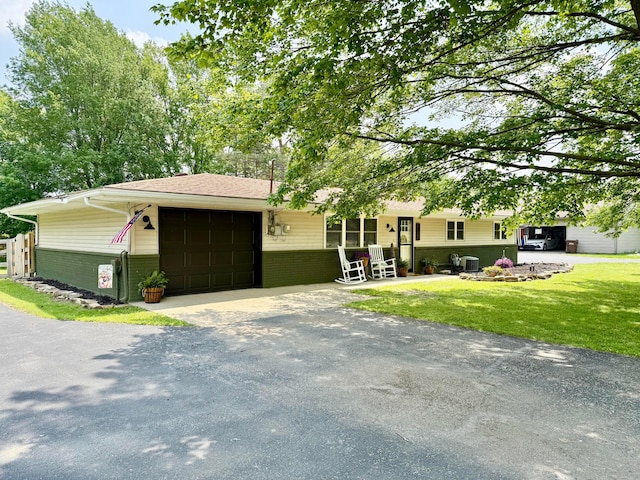 1855 Itawamba Trl, London, OH 43140 - view of front of property featuring a garage, driveway, brick siding, and a front yard