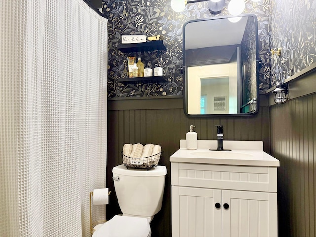 1855 Itawamba Trl, London, OH 43140 - full bath featuring wallpapered walls, toilet, vanity, wainscoting, and a shower with shower curtain