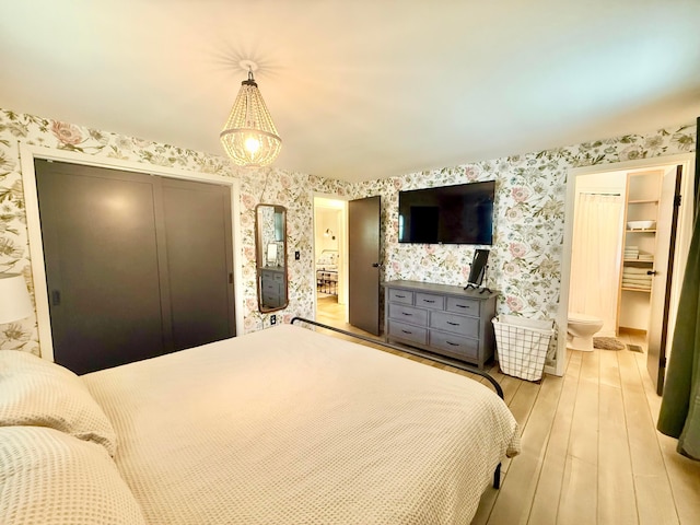1855 Itawamba Trl, London, OH 43140 - bedroom featuring wallpapered walls, hardwood / wood-style flooring, a chandelier, and connected bathroom