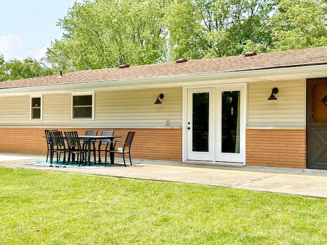 1855 Itawamba Trl, London, OH 43140 - rear view of house with brick siding, a patio area, a yard, and roof with shingles