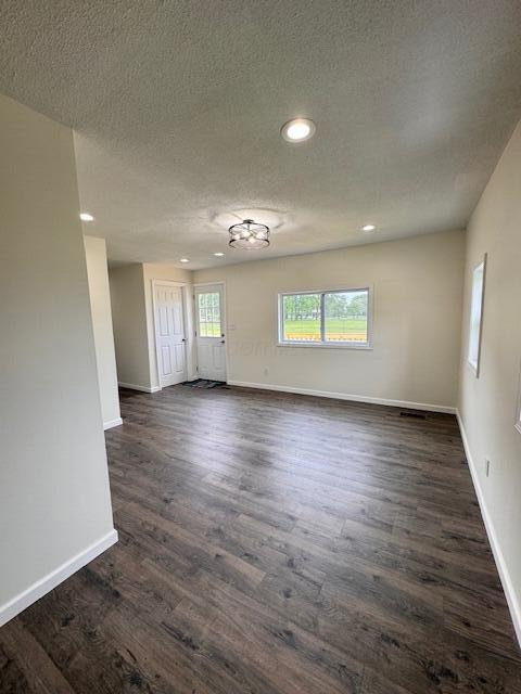 1729 E 17th Ave, Columbus, OH 43219 - empty room with dark wood-style floors, baseboards, a textured ceiling, and recessed lighting
