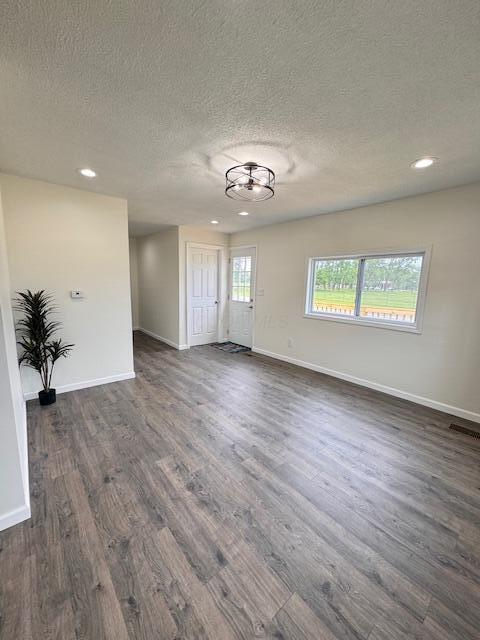 1729 E 17th Ave, Columbus, OH 43219 - unfurnished room with a textured ceiling, dark wood-style flooring, baseboards, and recessed lighting
