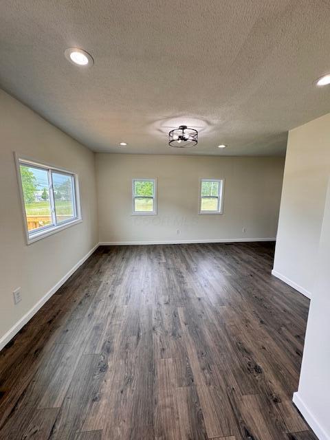 1729 E 17th Ave, Columbus, OH 43219 - empty room featuring a textured ceiling, dark wood finished floors, baseboards, and recessed lighting