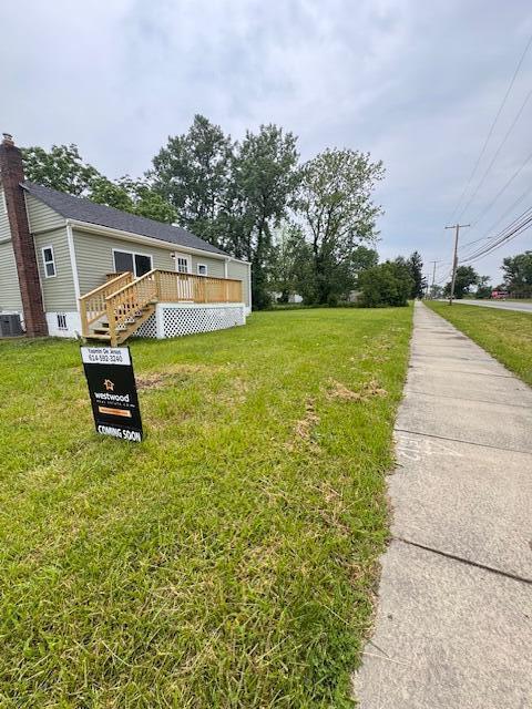 1729 E 17th Ave, Columbus, OH 43219 - view of grassy yard featuring a deck and central AC unit