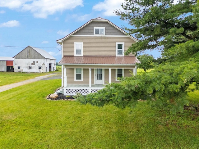 3795 Morral Kirkpatrick Rd E, Marion, OH 43302 - view of front facade with covered porch, a front lawn, and metal roof