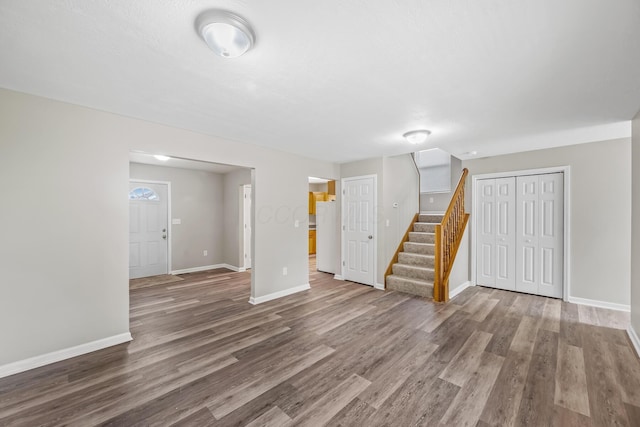 845 Bennett St, Marion, OH 43302 - unfurnished living room with stairway, wood finished floors, and baseboards