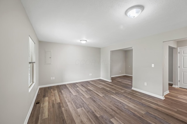 845 Bennett St, Marion, OH 43302 - spare room featuring dark wood finished floors, baseboards, and electric panel