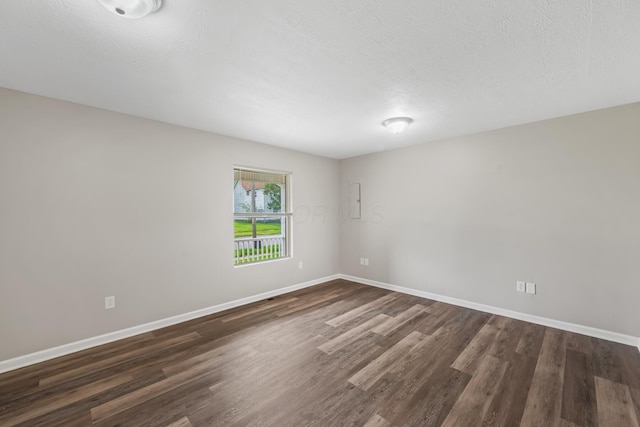845 Bennett St, Marion, OH 43302 - empty room featuring dark wood finished floors, baseboards, and a textured ceiling