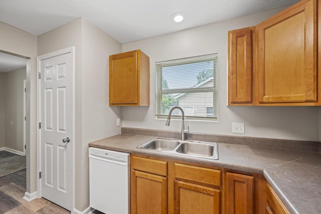 845 Bennett St, Marion, OH 43302 - kitchen with dishwasher, a sink, light wood-style floors, and brown cabinets