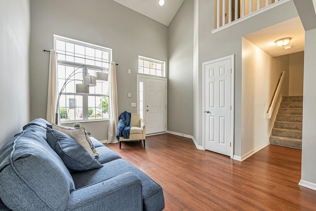 8281 Deering Oaks Dr, Blacklick, OH 43004 - living area featuring high vaulted ceiling, wood finished floors, baseboards, and stairway