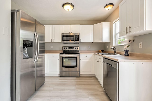 8281 Deering Oaks Dr, Blacklick, OH 43004 - kitchen featuring stainless steel appliances, a sink, and white cabinets