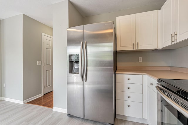 8281 Deering Oaks Dr, Blacklick, OH 43004 - kitchen with appliances with stainless steel finishes, light wood-style flooring, white cabinets, and light countertops