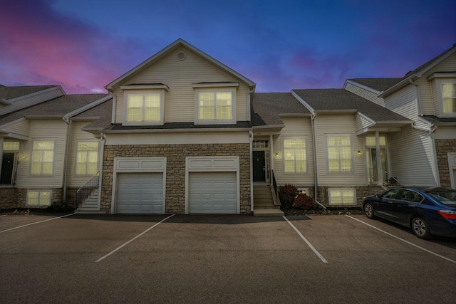 8281 Deering Oaks Dr, Blacklick, OH 43004 - view of property featuring stone siding, an attached garage, and driveway