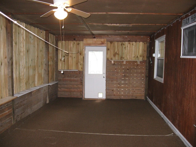 252 Randolph St, Wilmington, OH 45177 - empty room featuring wood walls, carpet flooring, and ceiling fan