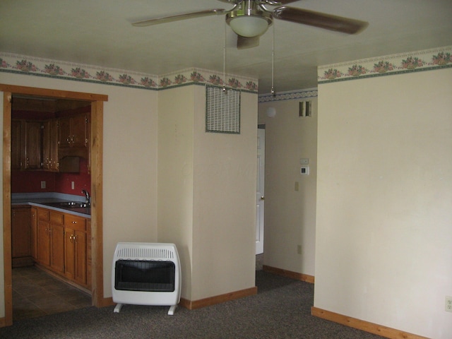 252 Randolph St, Wilmington, OH 45177 - unfurnished room with heating unit, a ceiling fan, a sink, and dark carpet