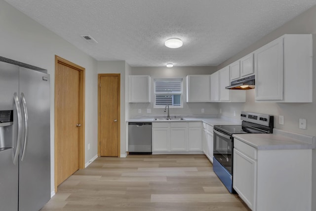 2563 Bristlecone Ln, Grove City, OH 43123 - kitchen with appliances with stainless steel finishes, a sink, under cabinet range hood, light wood-style floors, and white cabinetry
