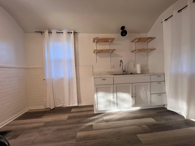 2296 Joyce Ave, Columbus, OH 43211 - kitchen with open shelves, lofted ceiling, a sink, dark wood-style flooring, and light stone countertops