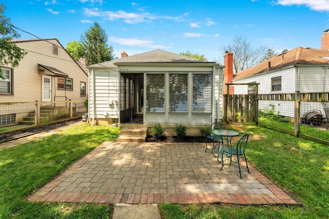 525 E Como Ave, Columbus, OH 43202 - back of property with a sunroom, a patio area, and a chimney
