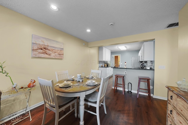 4654 Collingville Way, Columbus, OH 43230 - dining area featuring dark wood-type flooring, recessed lighting, baseboards, and a textured ceiling
