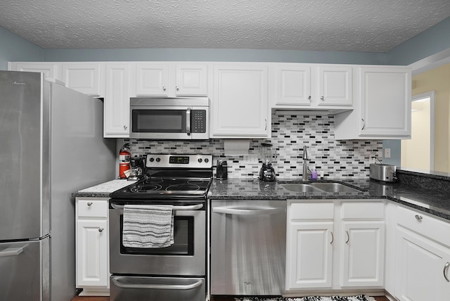 4654 Collingville Way, Columbus, OH 43230 - kitchen with appliances with stainless steel finishes, a sink, white cabinetry, and tasteful backsplash