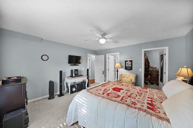 4654 Collingville Way, Columbus, OH 43230 - bedroom with light carpet, a walk in closet, baseboards, a ceiling fan, and a textured ceiling