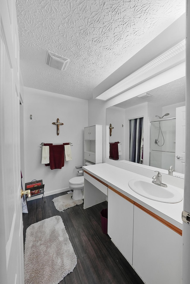 4654 Collingville Way, Columbus, OH 43230 - bathroom with vanity, a shower, wood finished floors, a textured ceiling, and toilet