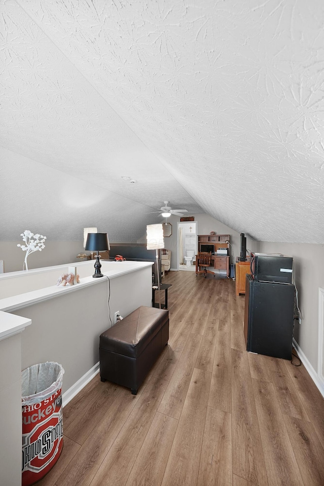 4654 Collingville Way, Columbus, OH 43230 - bonus room with a textured ceiling, wood finished floors, lofted ceiling, and baseboards