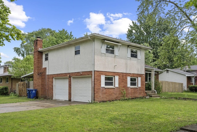 5754 Loganwood Rd, Columbus, OH 43229 - back of house with driveway, a garage, a chimney, stucco siding, and brick siding