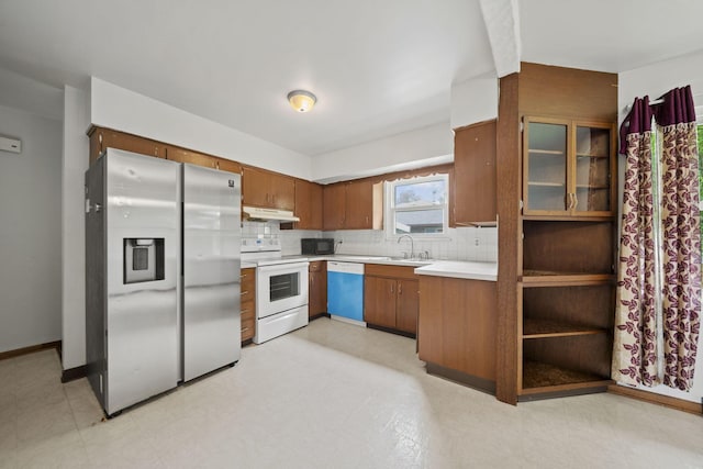 5754 Loganwood Rd, Columbus, OH 43229 - kitchen featuring white appliances, under cabinet range hood, light countertops, and tasteful backsplash