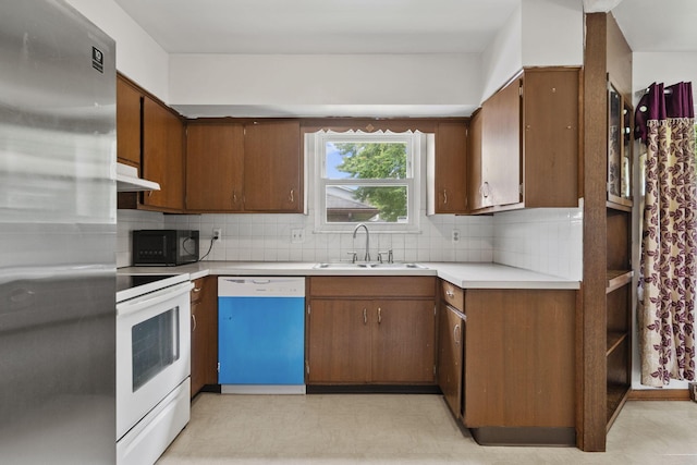 5754 Loganwood Rd, Columbus, OH 43229 - kitchen with dishwasher, electric stove, freestanding refrigerator, under cabinet range hood, and a sink